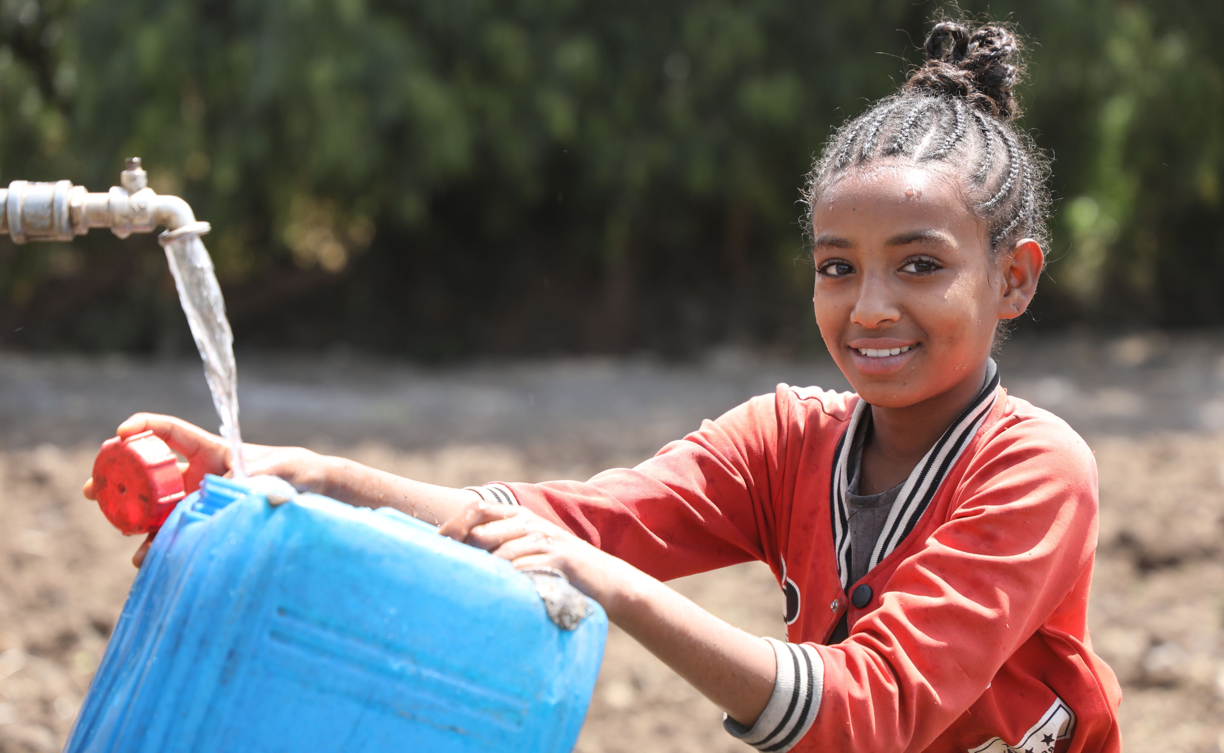 Zebirehan*, 13, gathering water. | Photo: Save the Children Ethiopia