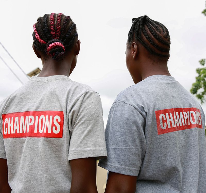 A schoolgirl with her branded school bag 'My Body, My Decision, My Right' in the community where Kpemeh*, 18 and Kuji*, 19 in Kailahun, Sierra Leone | Photo: Shona Hamilton / Save the Children