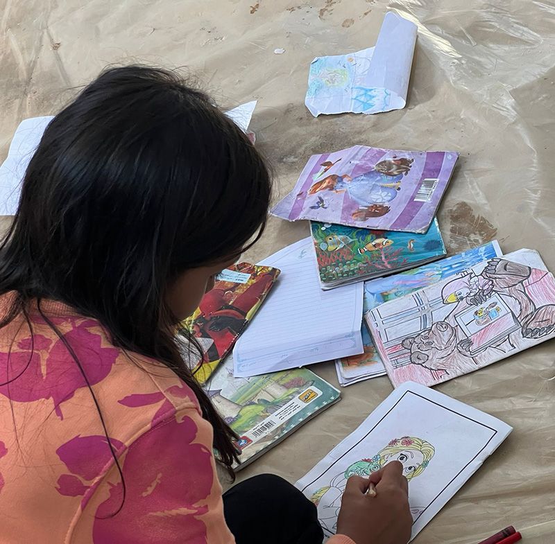 Areej*, 9, Hala*'s sister, drawing and colouring. | Photo: Save the Children